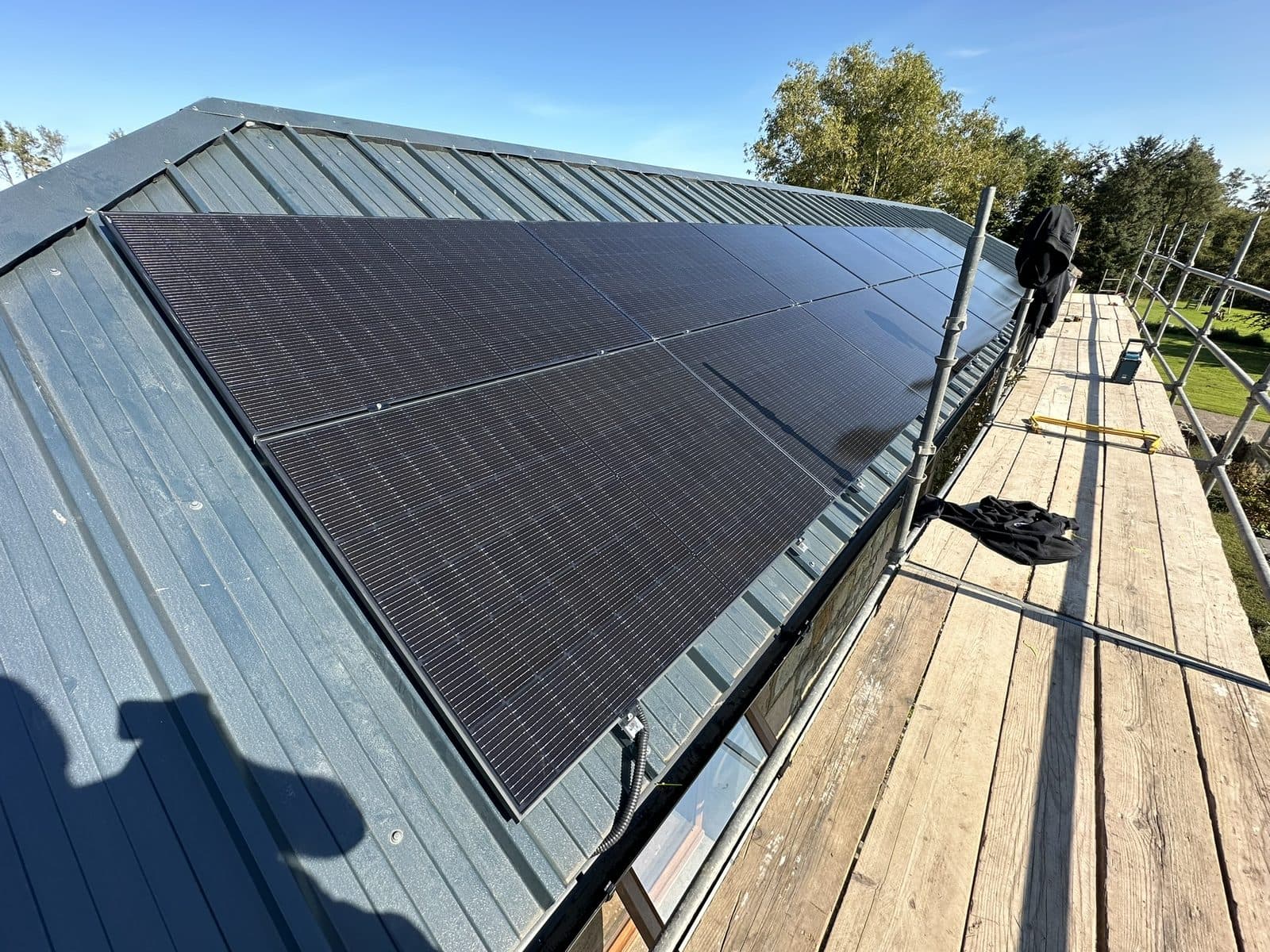 Black solar panels fitted to a standing seam roof