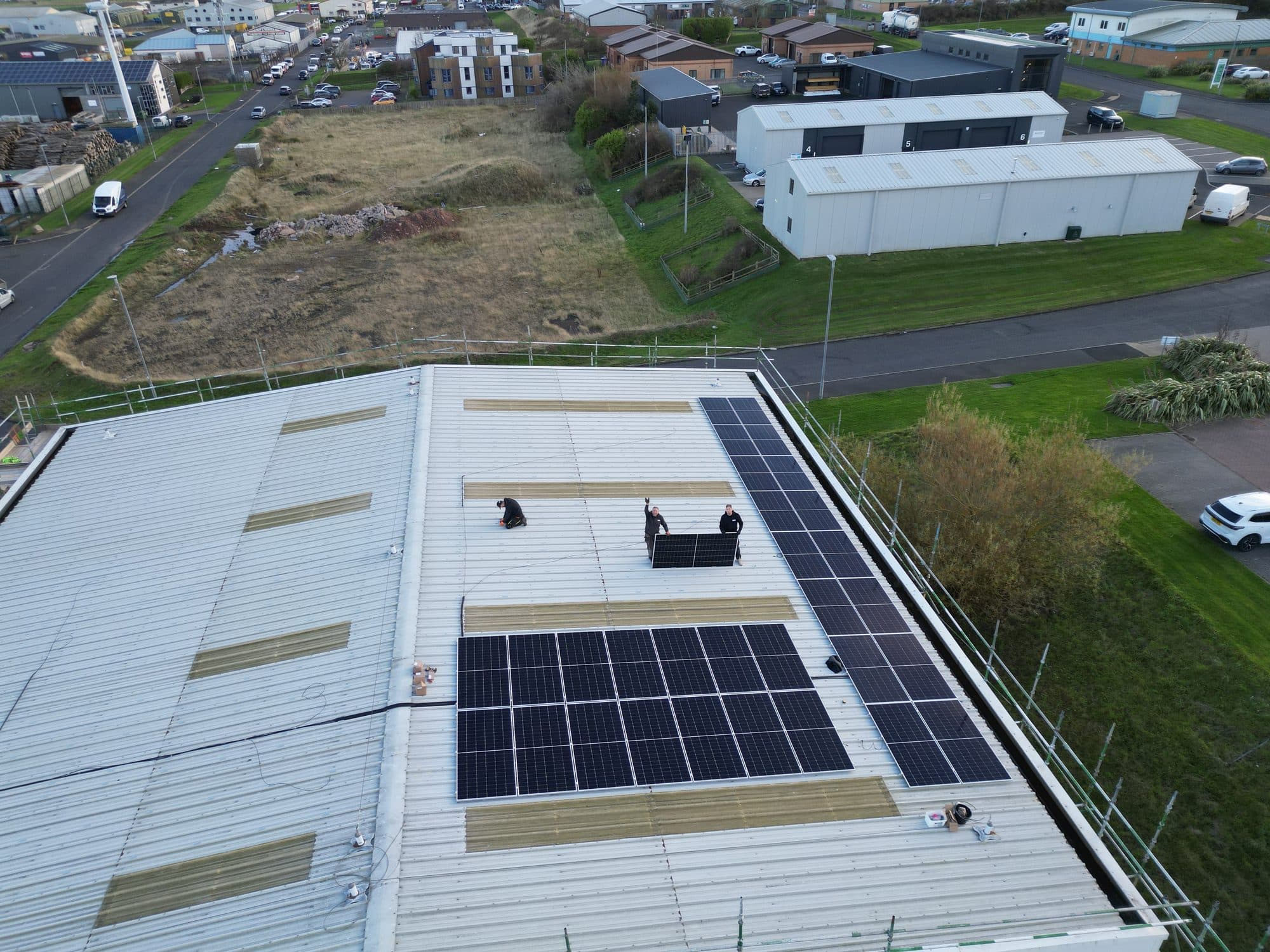 Drone view of a commercial roof with a solar array